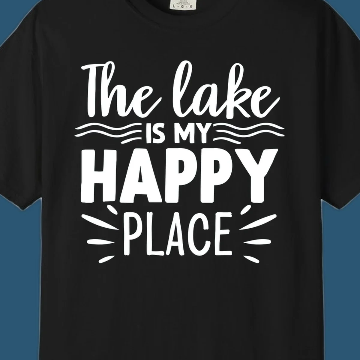 The lake is my happy place text design with wave and sun ray graphics.