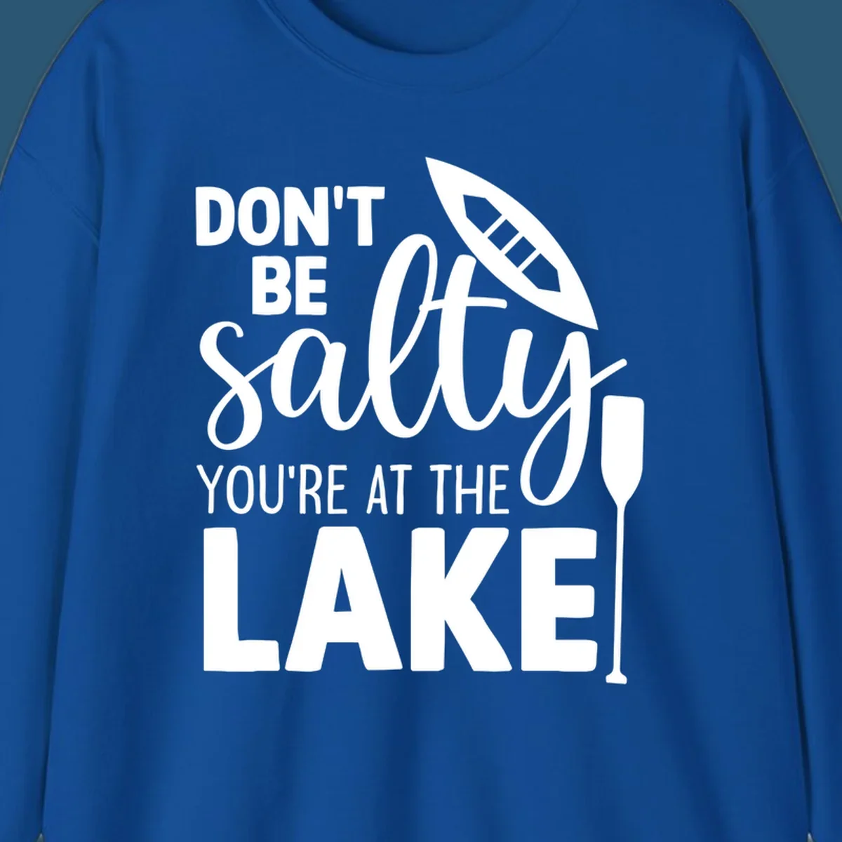 Don't be salty you're at the lake text with canoe and oar graphic.
