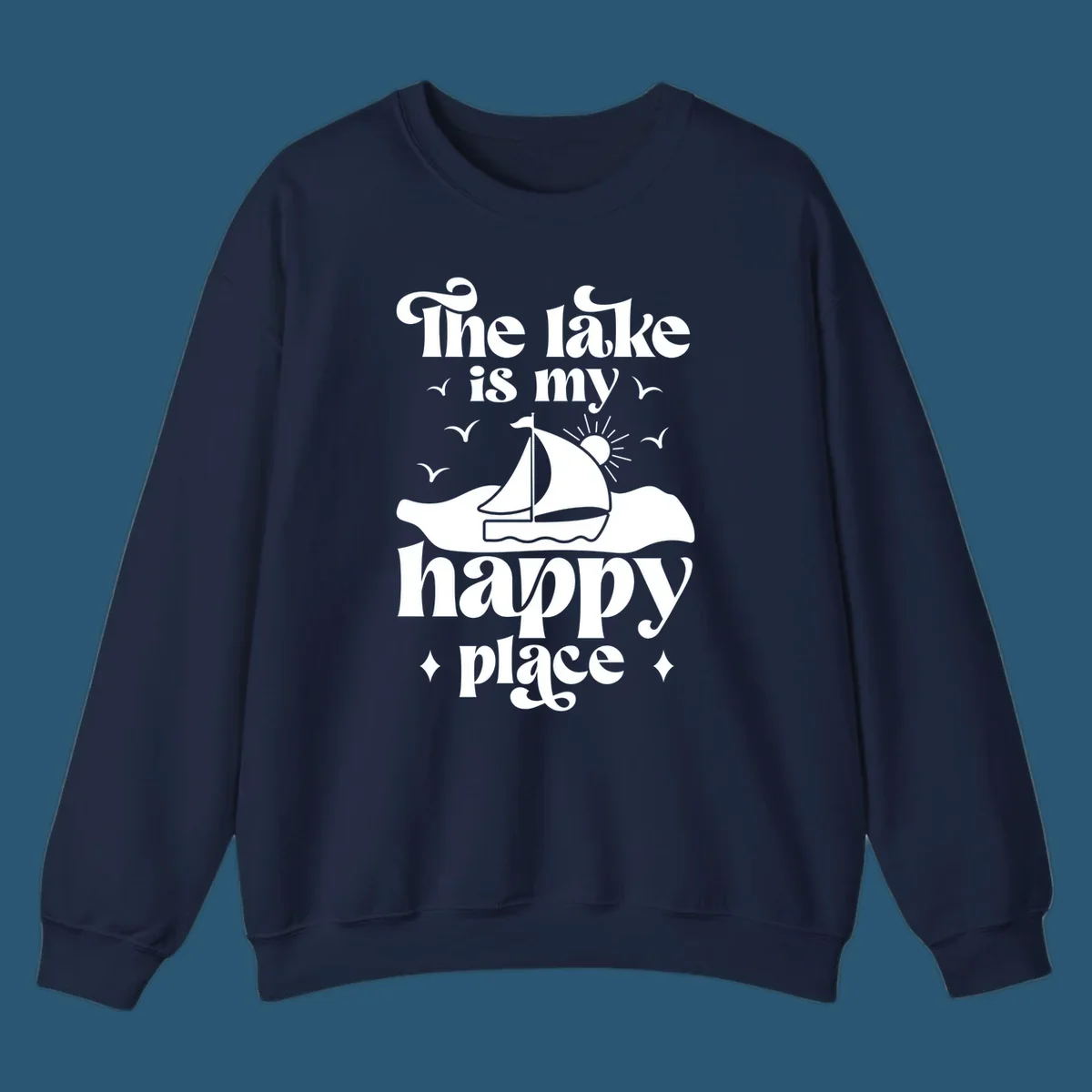 Retro text design 'The lake is my happy place' with sailboat, sun, and birds.