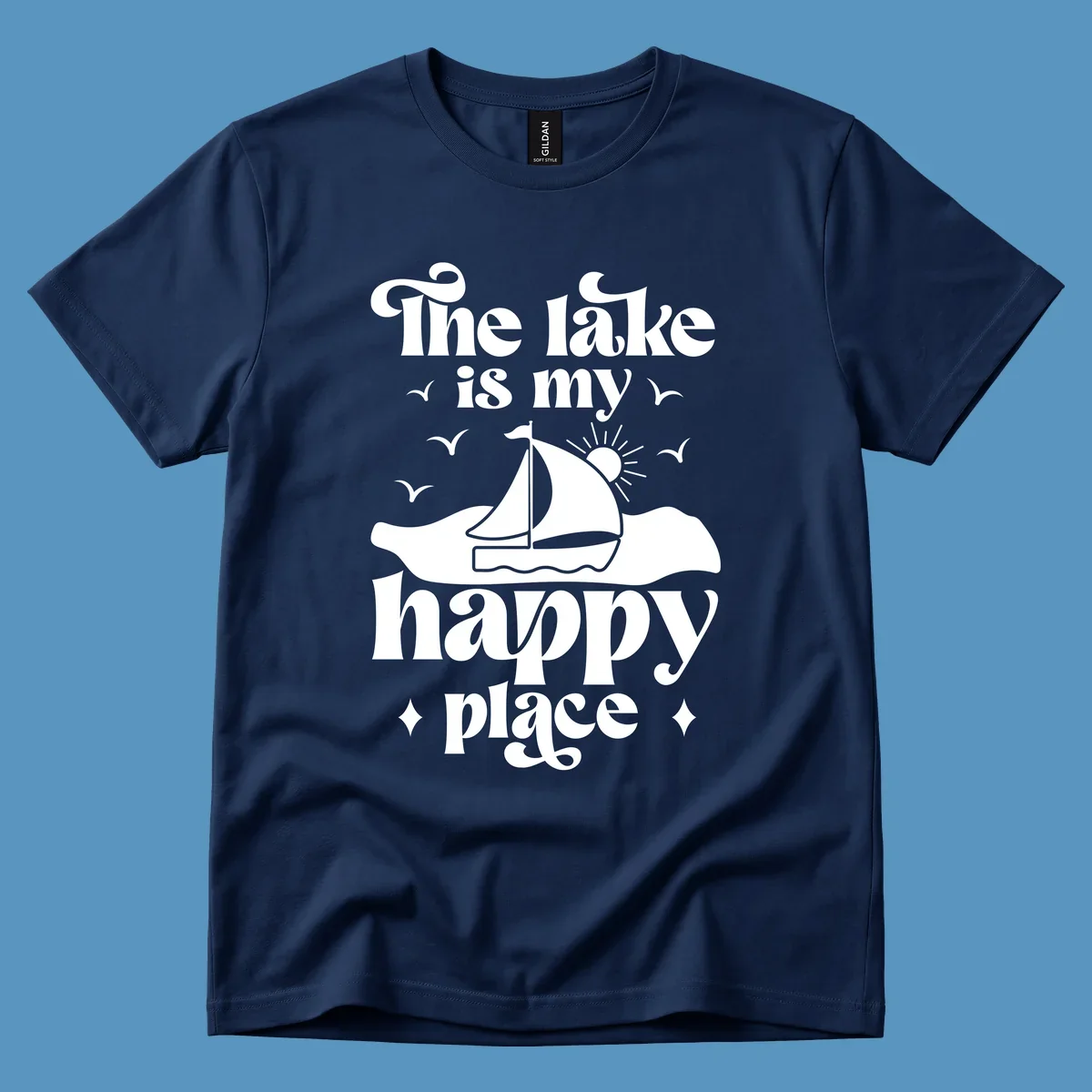 Retro text design 'The lake is my happy place' with sailboat, sun, and birds.