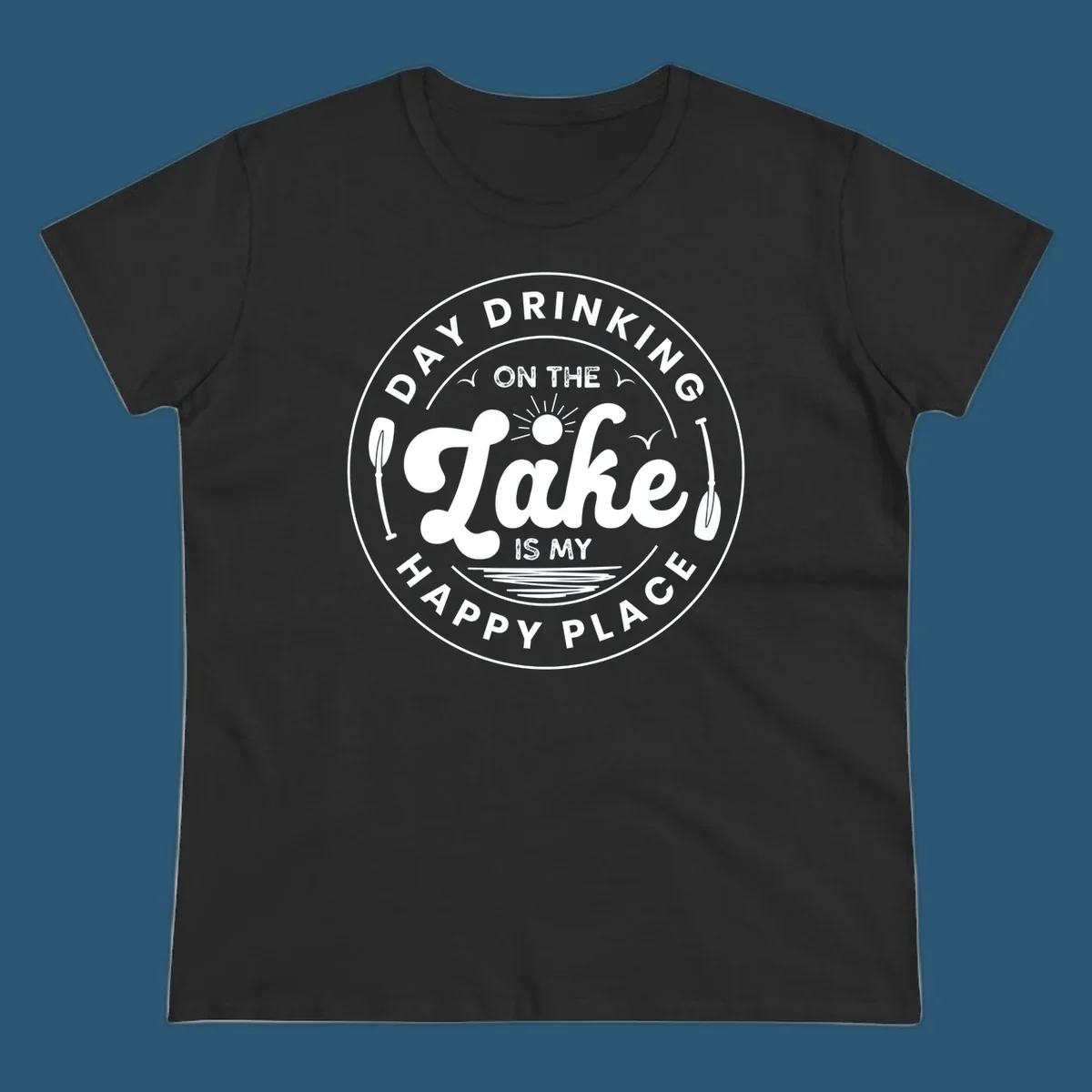 Circular badge design with text 'Day Drinking On The Lake Is My Happy Place' and lake-themed graphics.