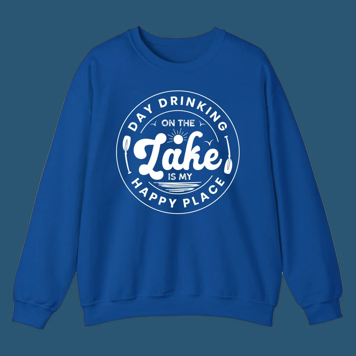 Circular badge design with text 'Day Drinking On The Lake Is My Happy Place' and lake-themed graphics.