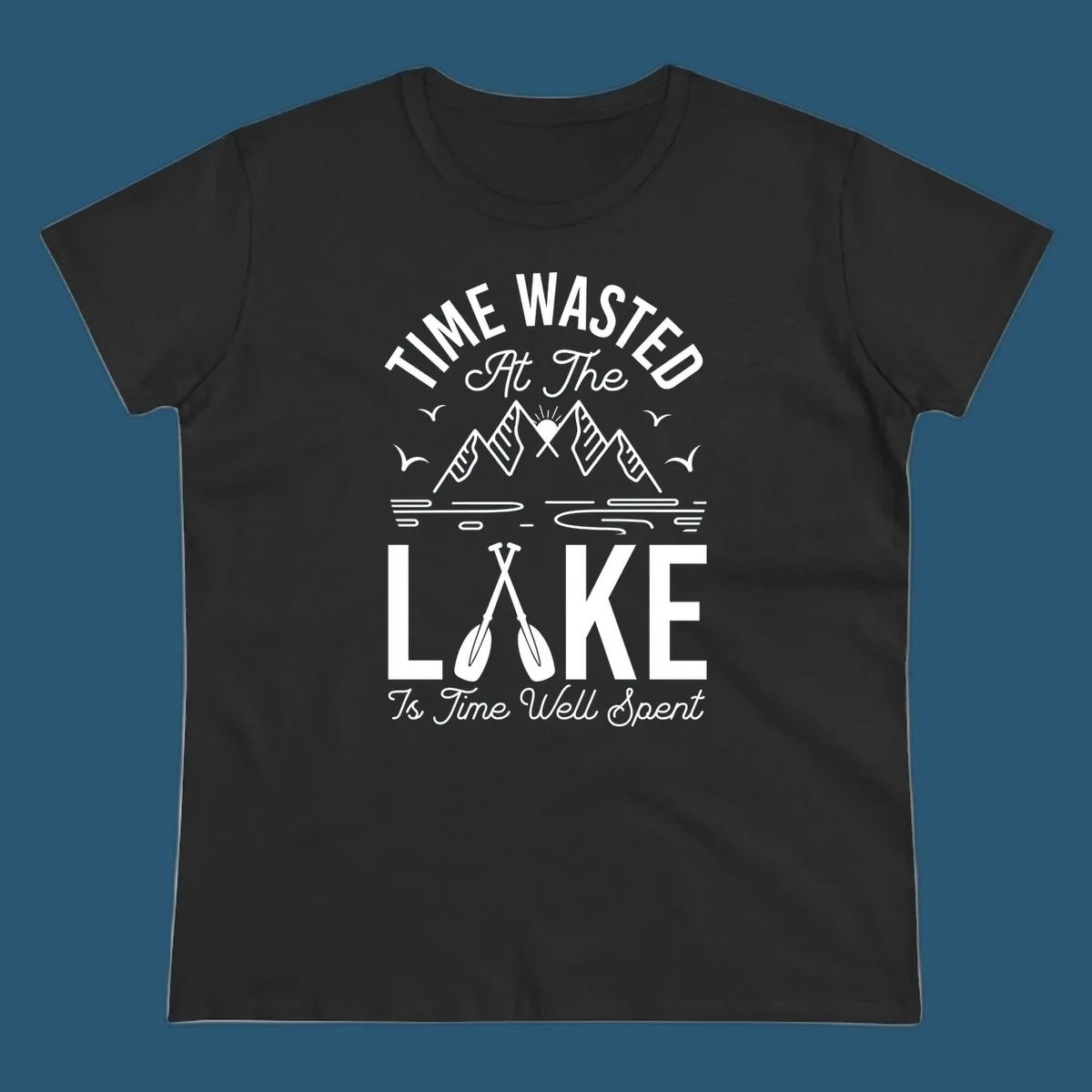 Illustration of mountains, sun, birds, and oars with text 'Time Wasted At The Lake Is Time Well Spent'.