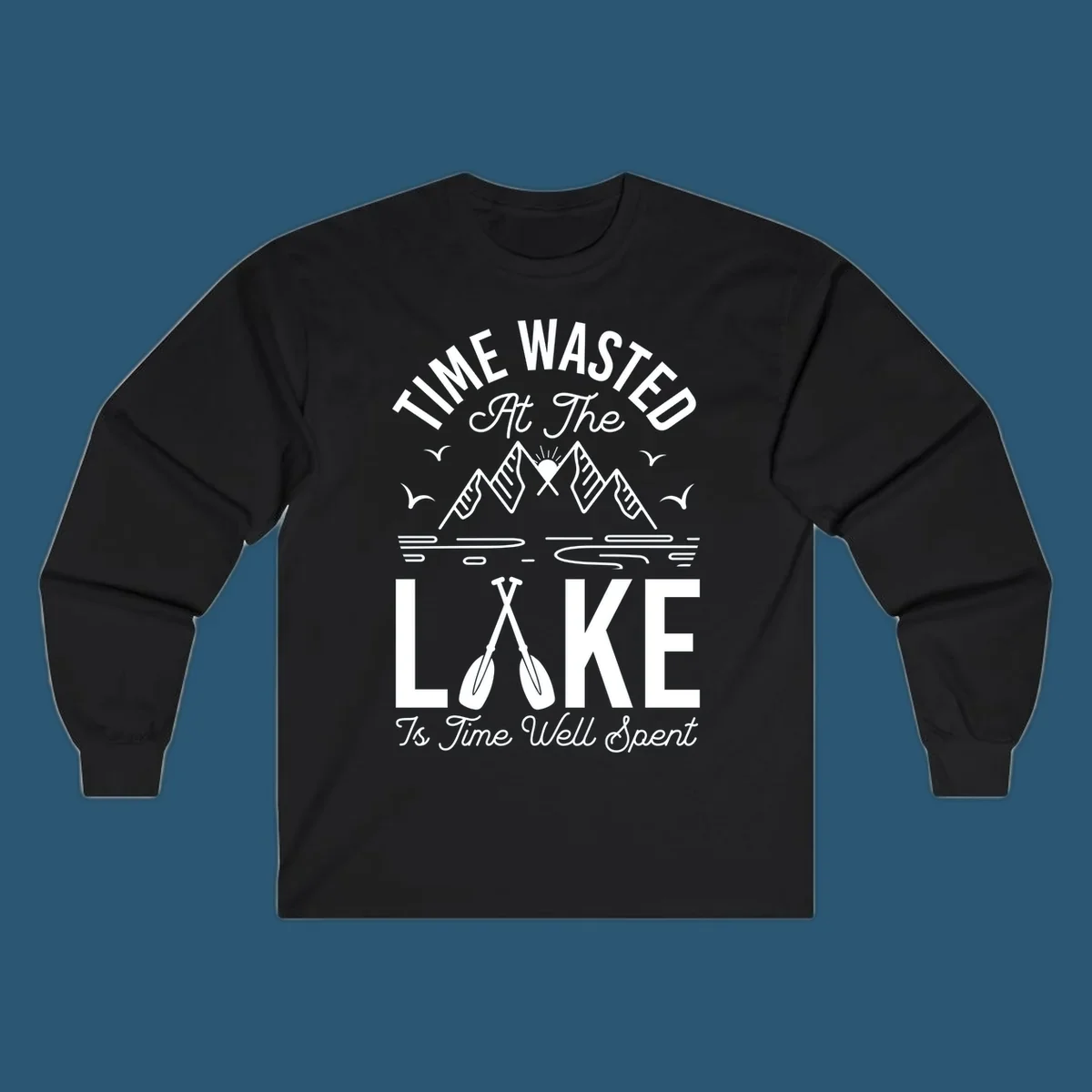 Illustration of mountains, sun, birds, and oars with text 'Time Wasted At The Lake Is Time Well Spent'.