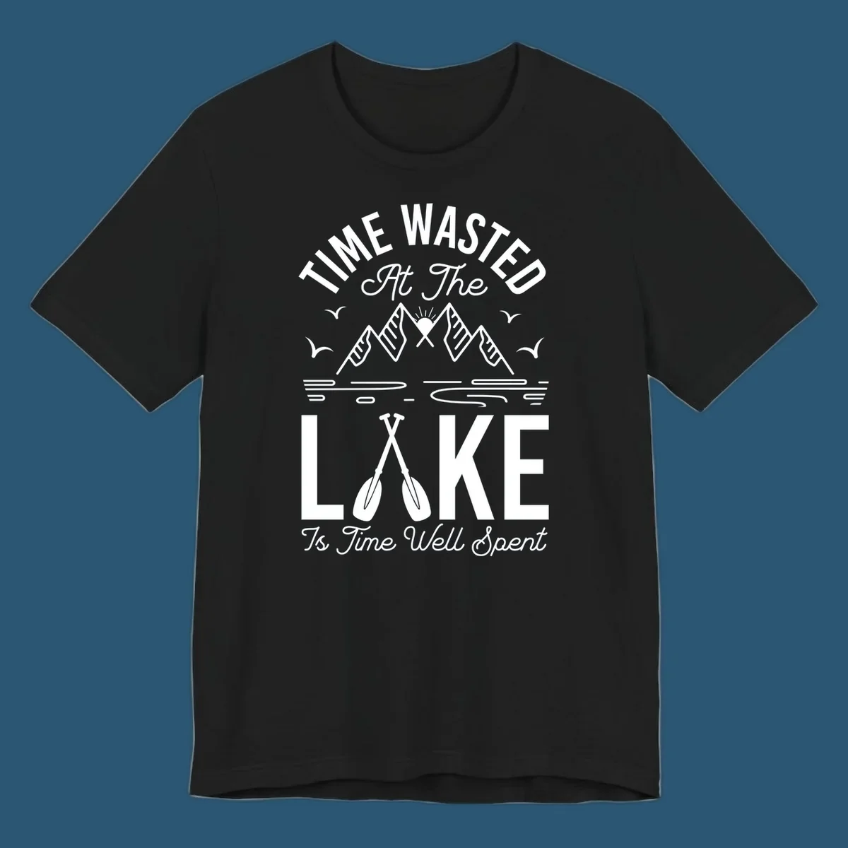 Illustration of mountains, sun, birds, and oars with text 'Time Wasted At The Lake Is Time Well Spent'.