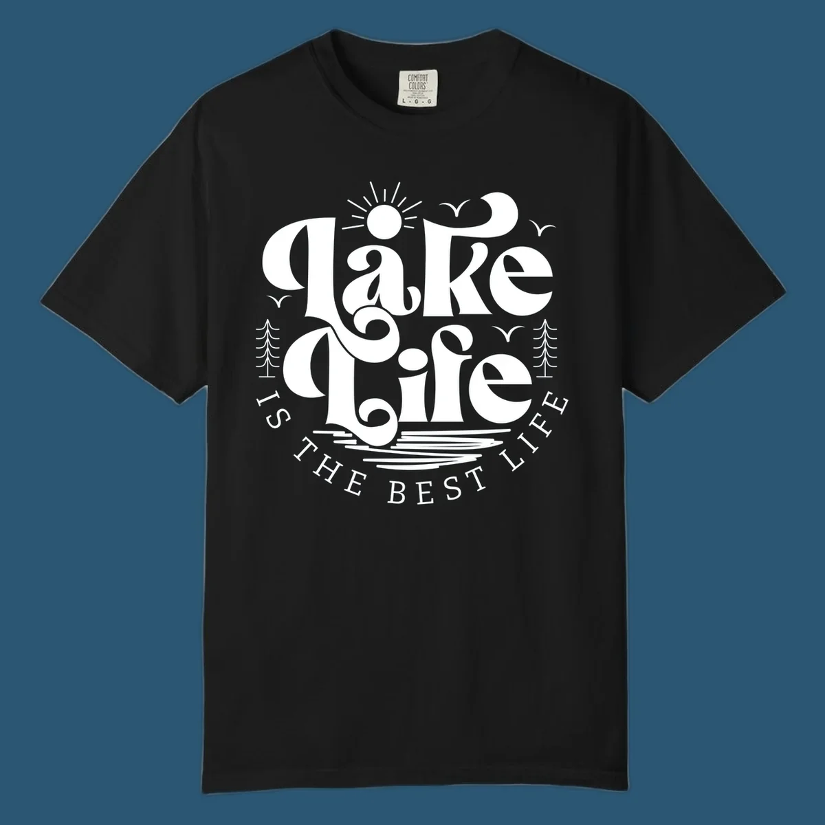 Lake life is the best life typography design with sun, birds, trees, and water elements.