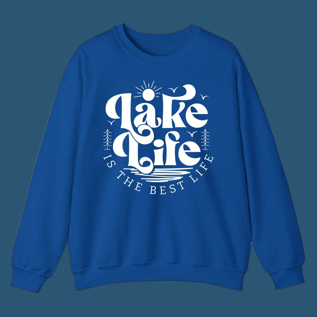 Lake life is the best life typography design with sun, birds, trees, and water elements.