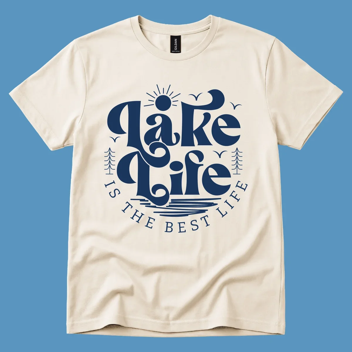 Lake life is the best life typography design with sun, birds, trees, and water elements.