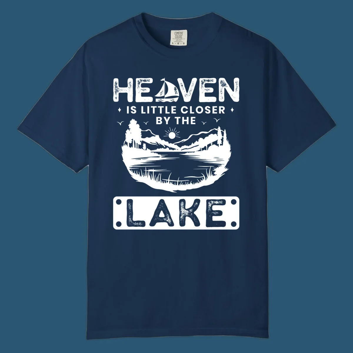 Heaven Is Little Closer By The Lake scenic design with lake, mountains, and sailboat.