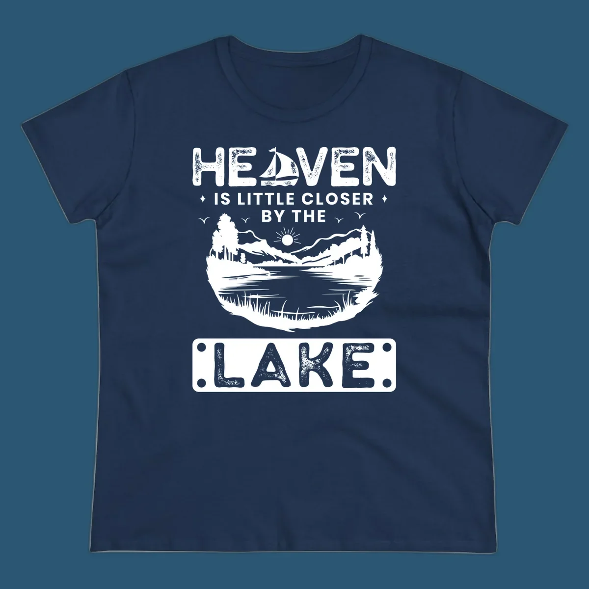 Heaven Is Little Closer By The Lake scenic design with lake, mountains, and sailboat.