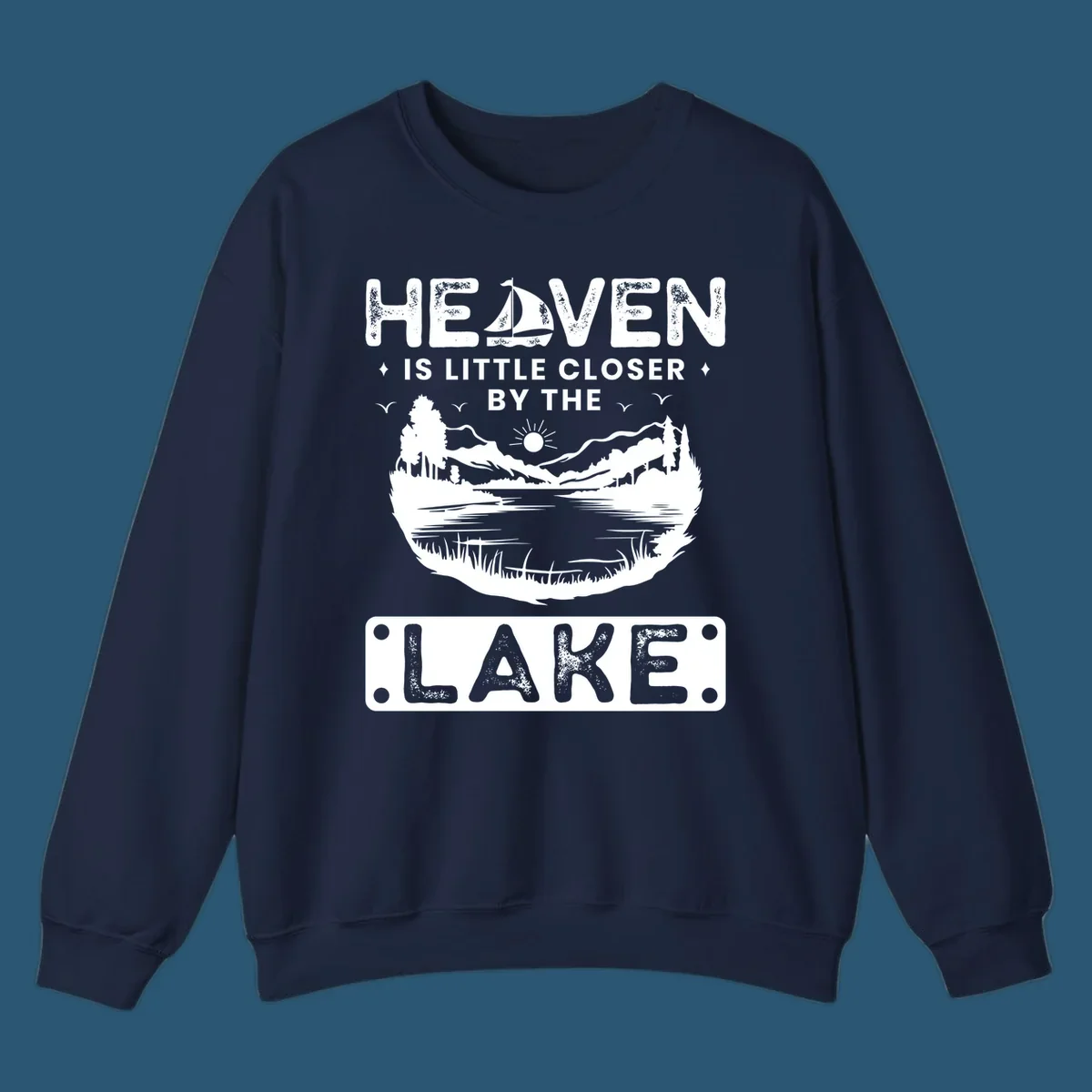 Heaven Is Little Closer By The Lake scenic design with lake, mountains, and sailboat.