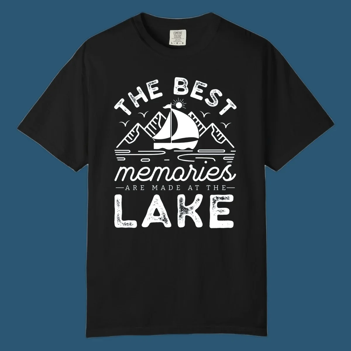 The Best Memories Are Made At The Lake design with mountains, sailboat, and text.