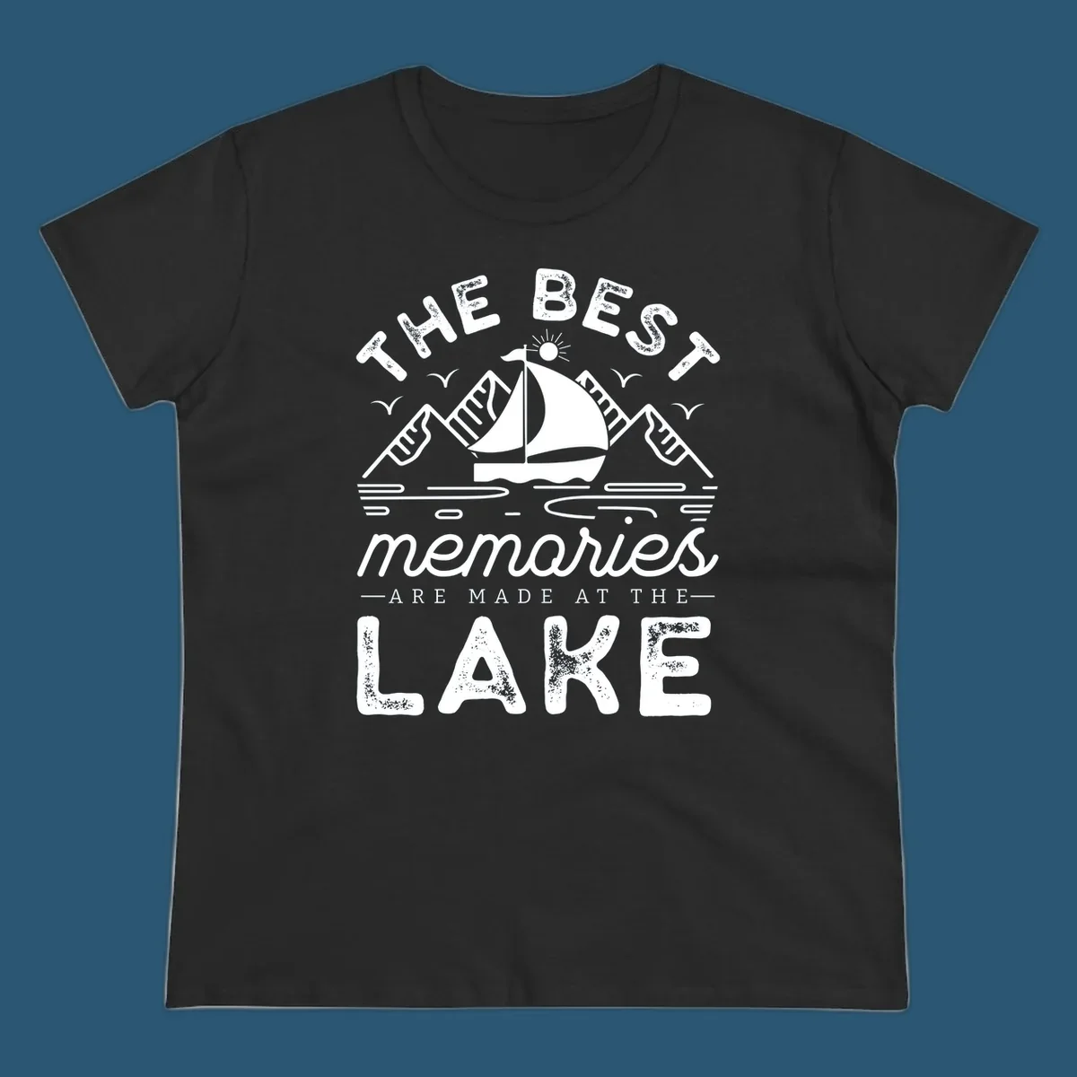 The Best Memories Are Made At The Lake design with mountains, sailboat, and text.