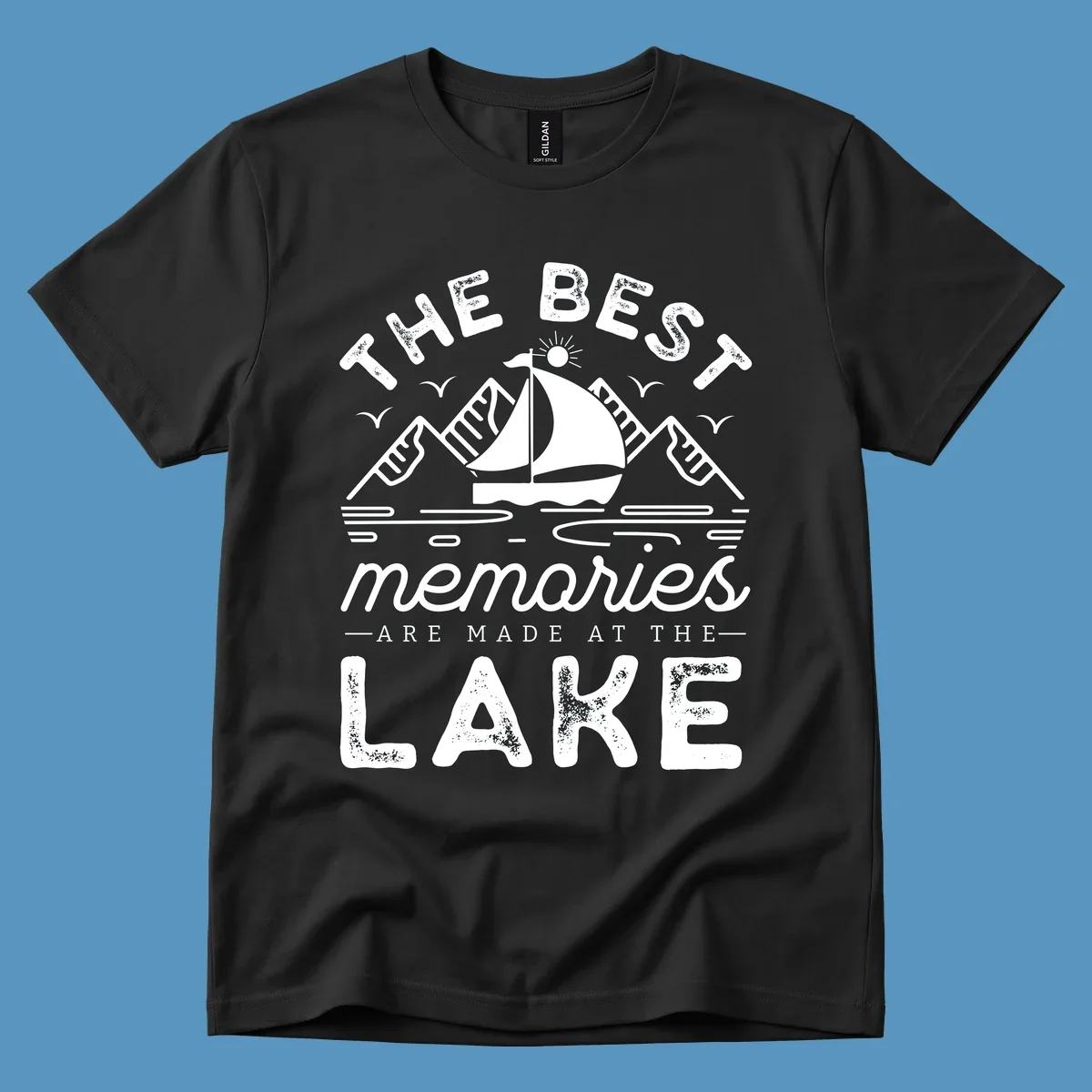 The Best Memories Are Made At The Lake design with mountains, sailboat, and text.