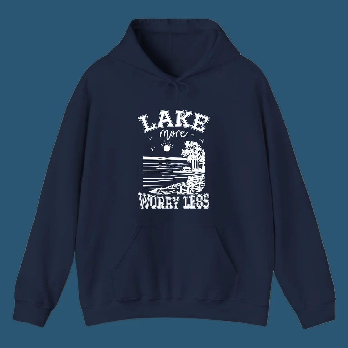 Lake More Worry Less scenic illustration with lake, trees, bench, and sun, white text on black, navy text on white.