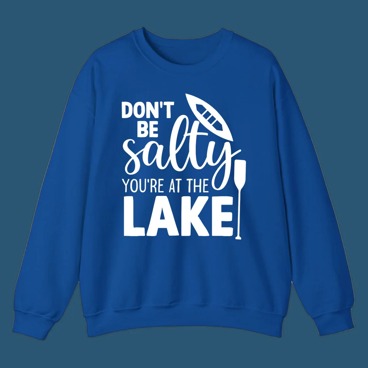 Don't be salty you're at the lake text with canoe and oar graphic.