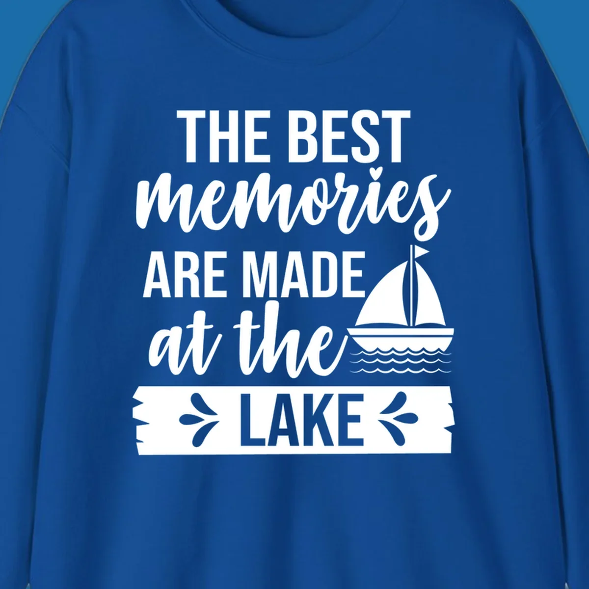 The Best Memories Are Made At The Lake text with sailboat graphic