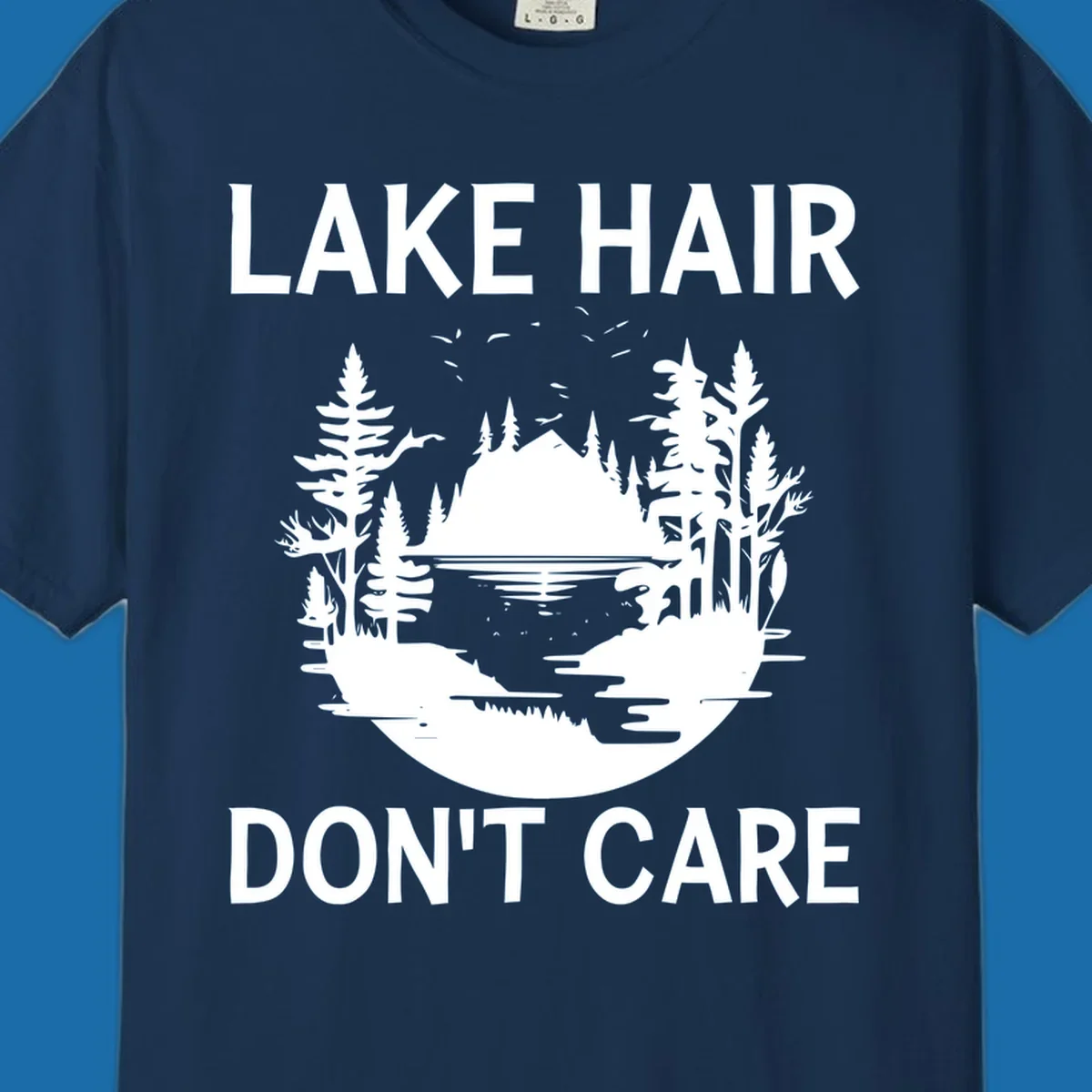 Lake Hair Don't Care design featuring a silhouette of a lake, trees, and mountains.