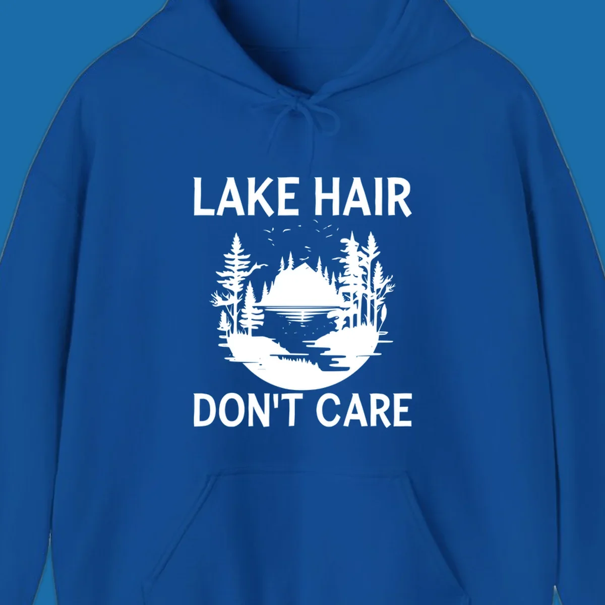 Lake Hair Don't Care design featuring a silhouette of a lake, trees, and mountains.