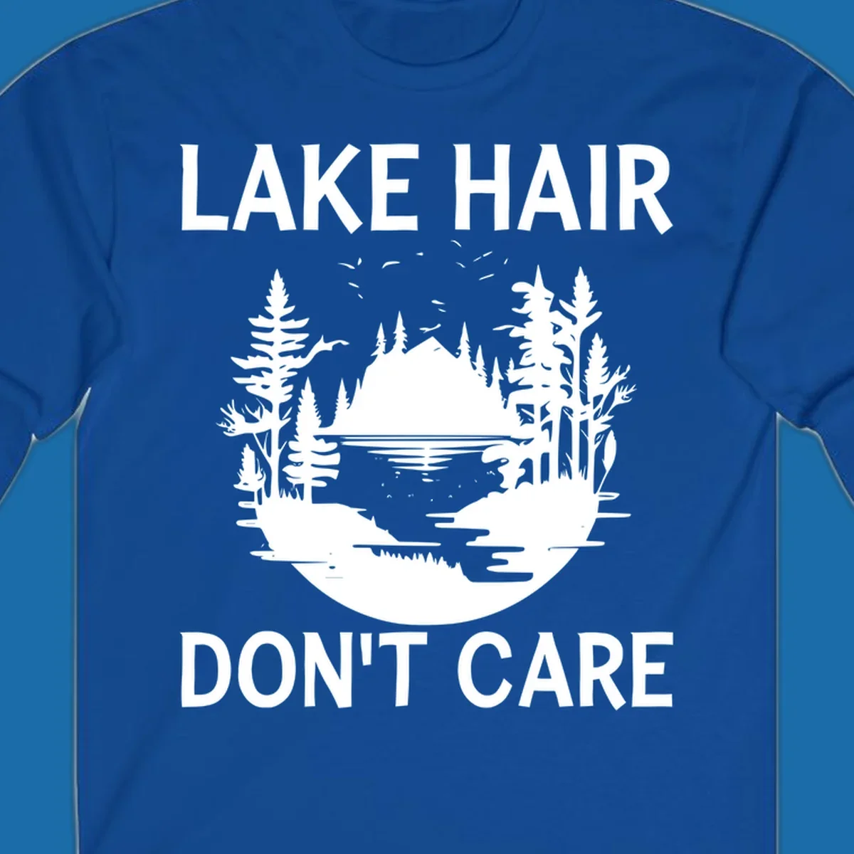 Lake Hair Don't Care design featuring a silhouette of a lake, trees, and mountains.