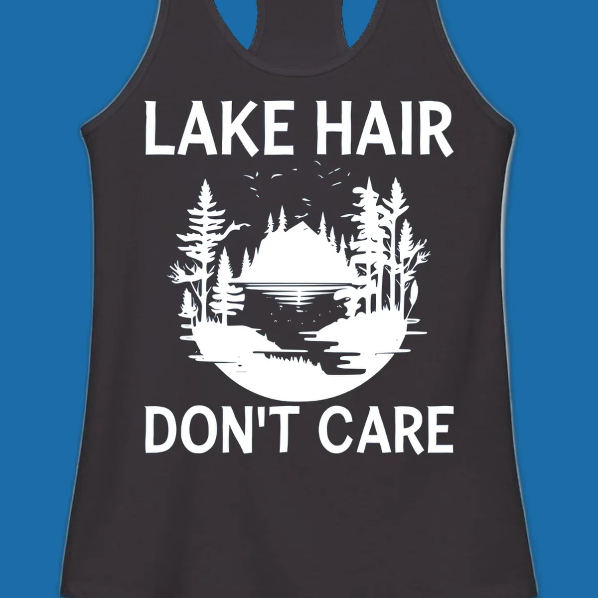 Lake Hair Don't Care design featuring a silhouette of a lake, trees, and mountains.