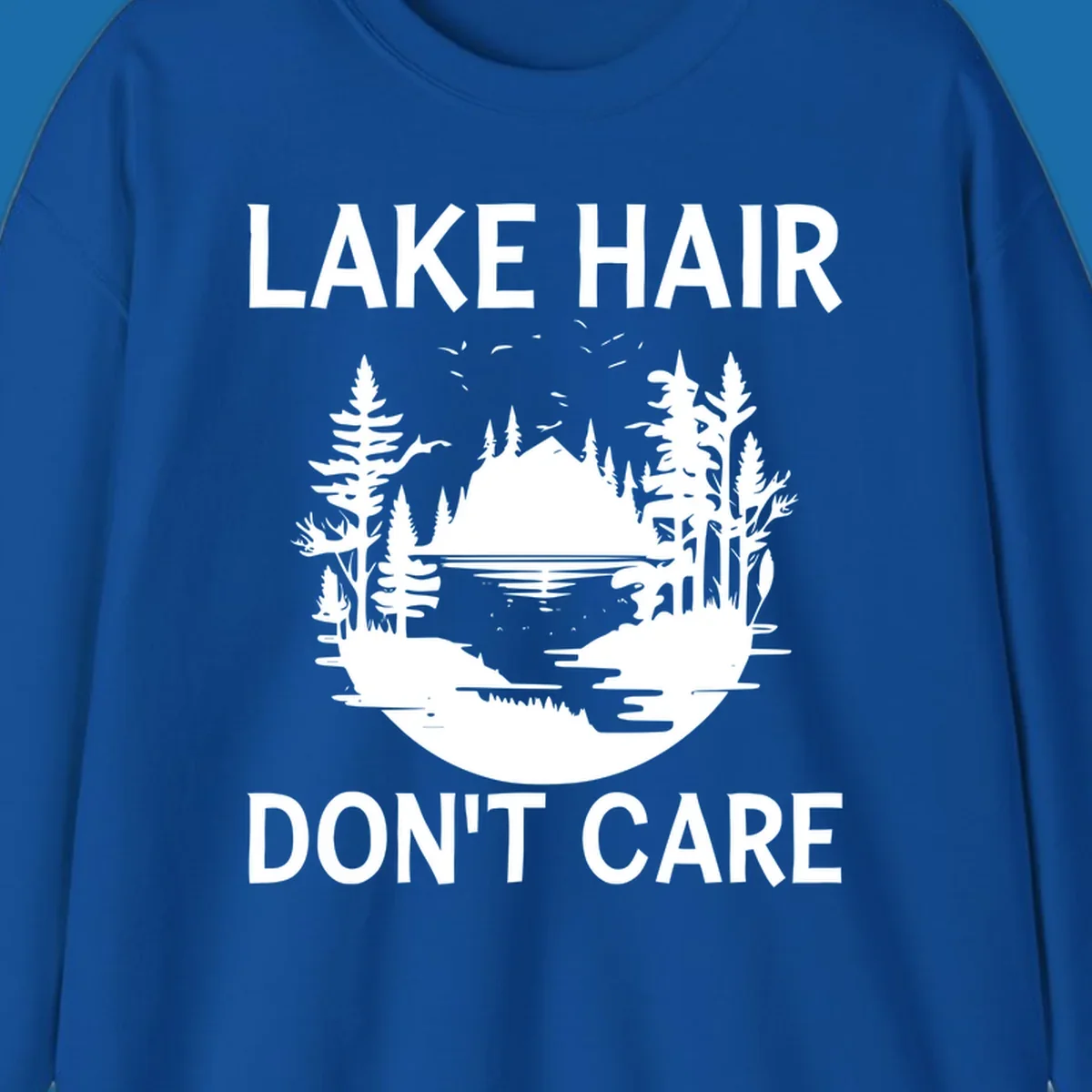 Lake Hair Don't Care design featuring a silhouette of a lake, trees, and mountains.