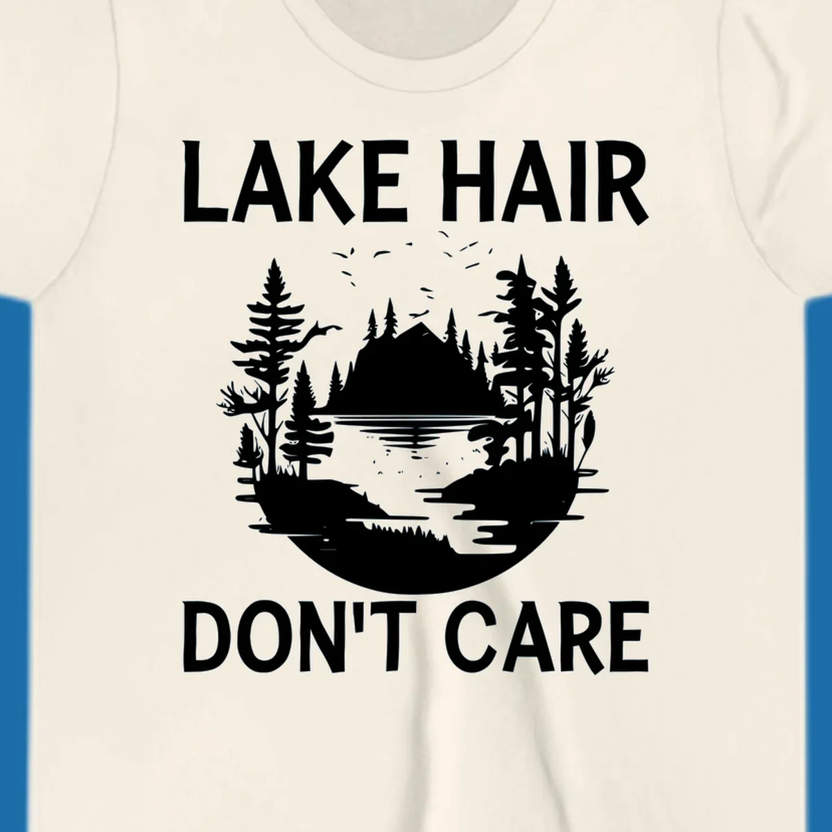 Lake Hair Don't Care design featuring a silhouette of a lake, trees, and mountains.