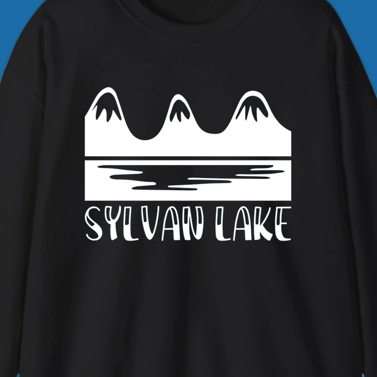 Sylvan Lake mountains reflected in water, with text 'SYLVAN LAKE'.