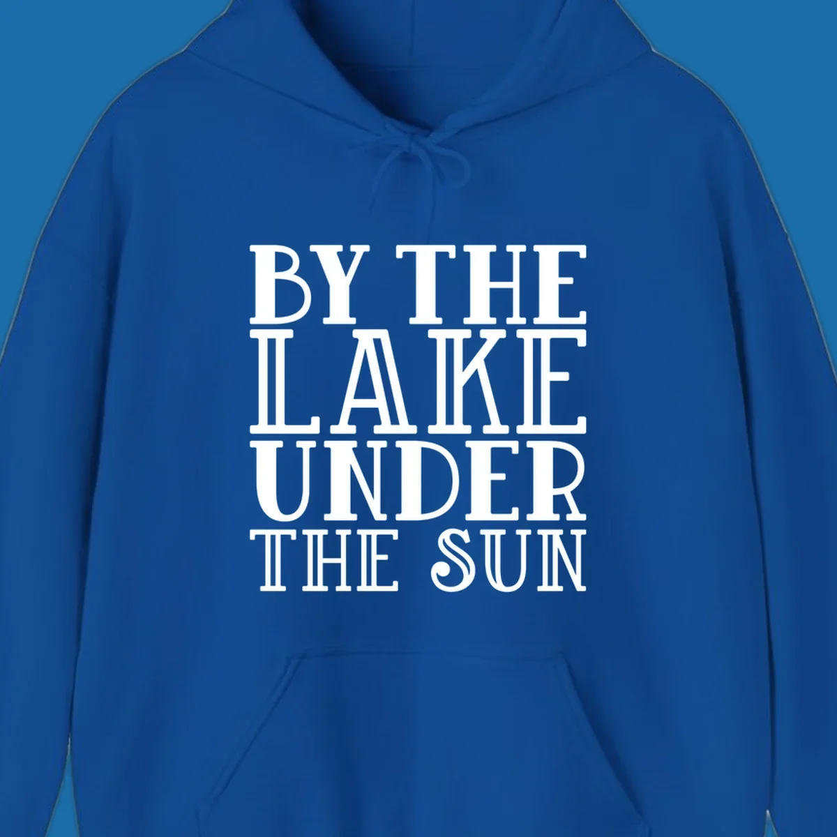 Text design 'BY THE LAKE UNDER THE SUN' in white serif font.