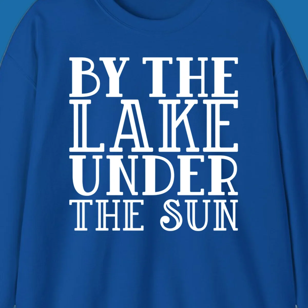 Text design 'BY THE LAKE UNDER THE SUN' in white serif font.