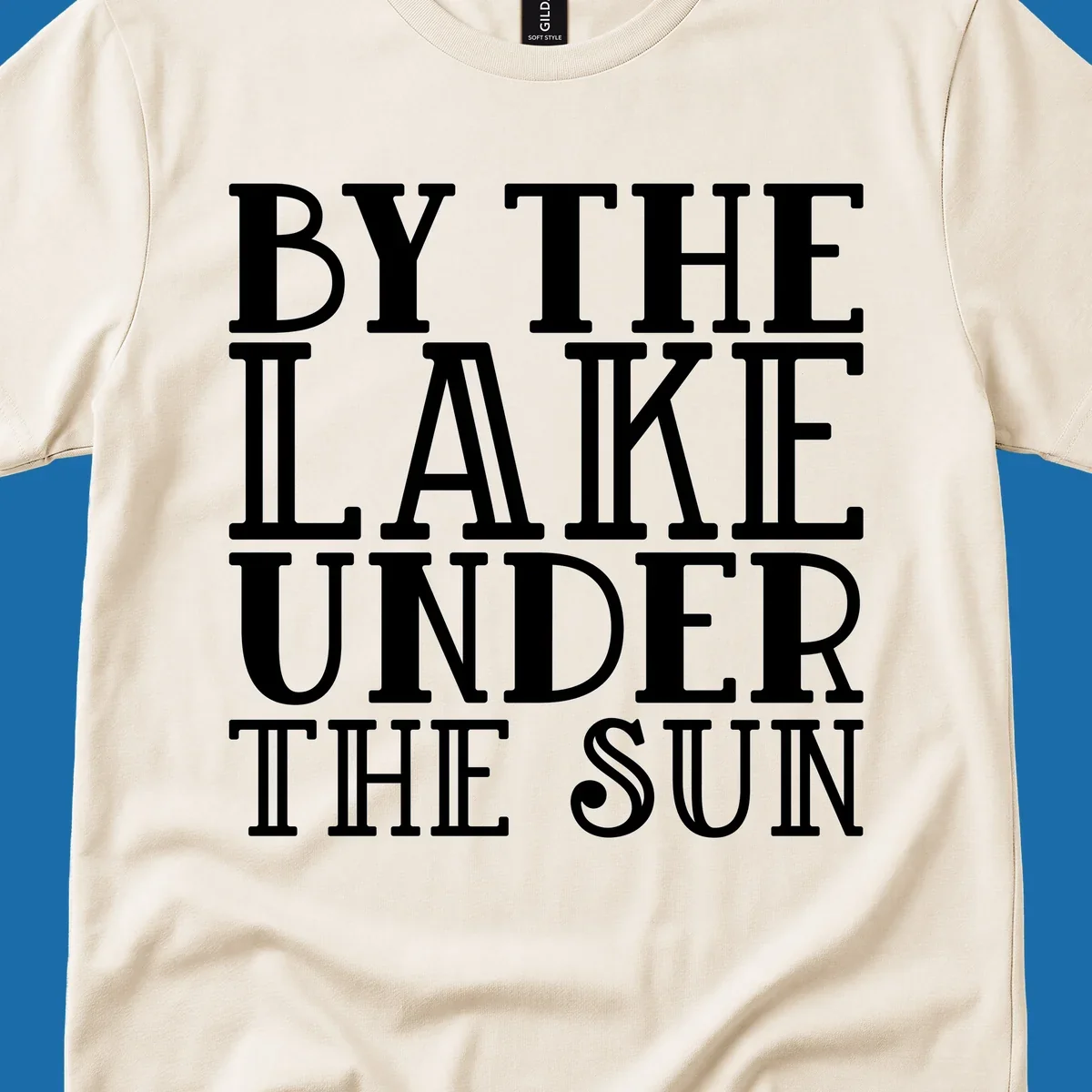 Text design 'BY THE LAKE UNDER THE SUN' in white serif font.
