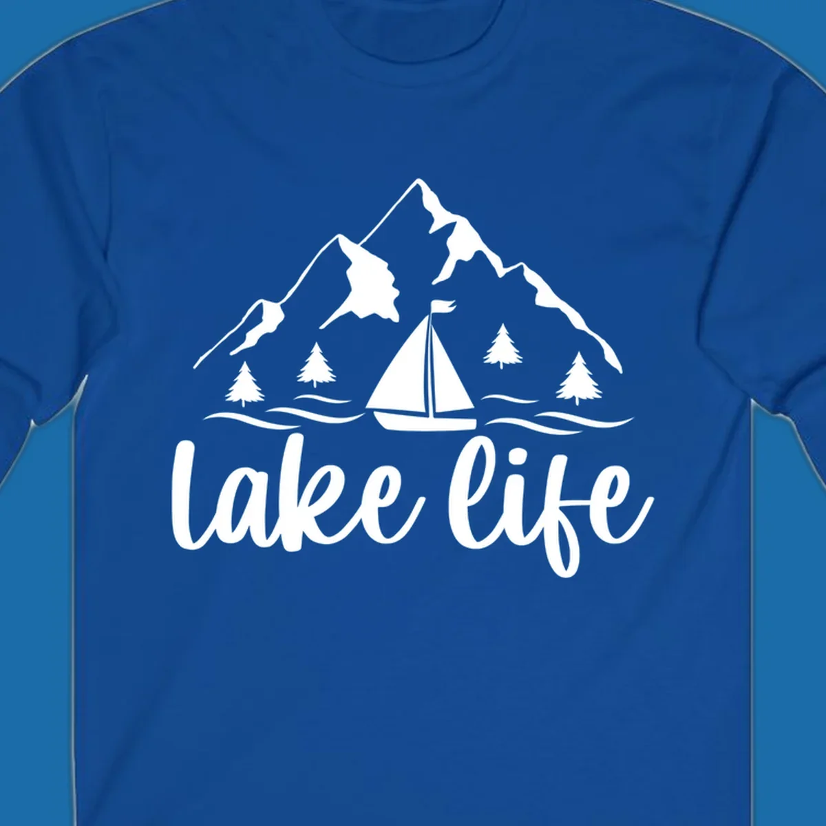 Lake life mountain sailboat scenic design with mountains, trees, sailboat, and text.