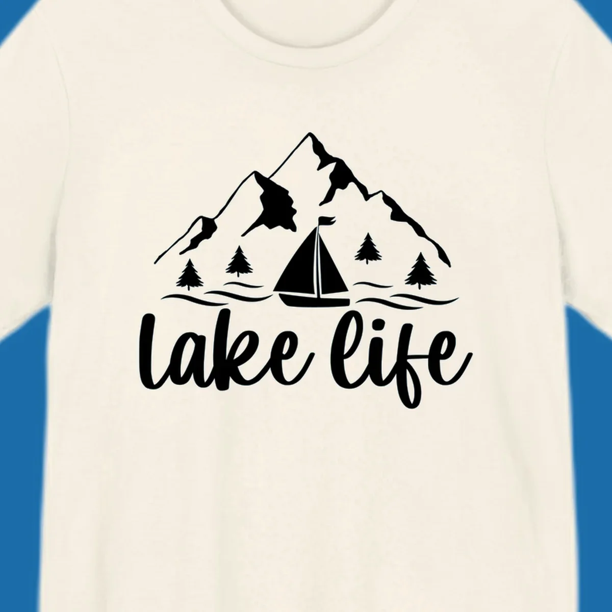 Lake life mountain sailboat scenic design with mountains, trees, sailboat, and text.