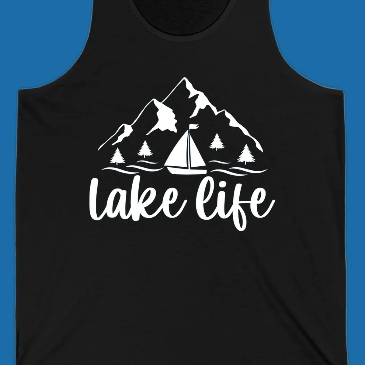 Lake life mountain sailboat scenic design with mountains, trees, sailboat, and text.