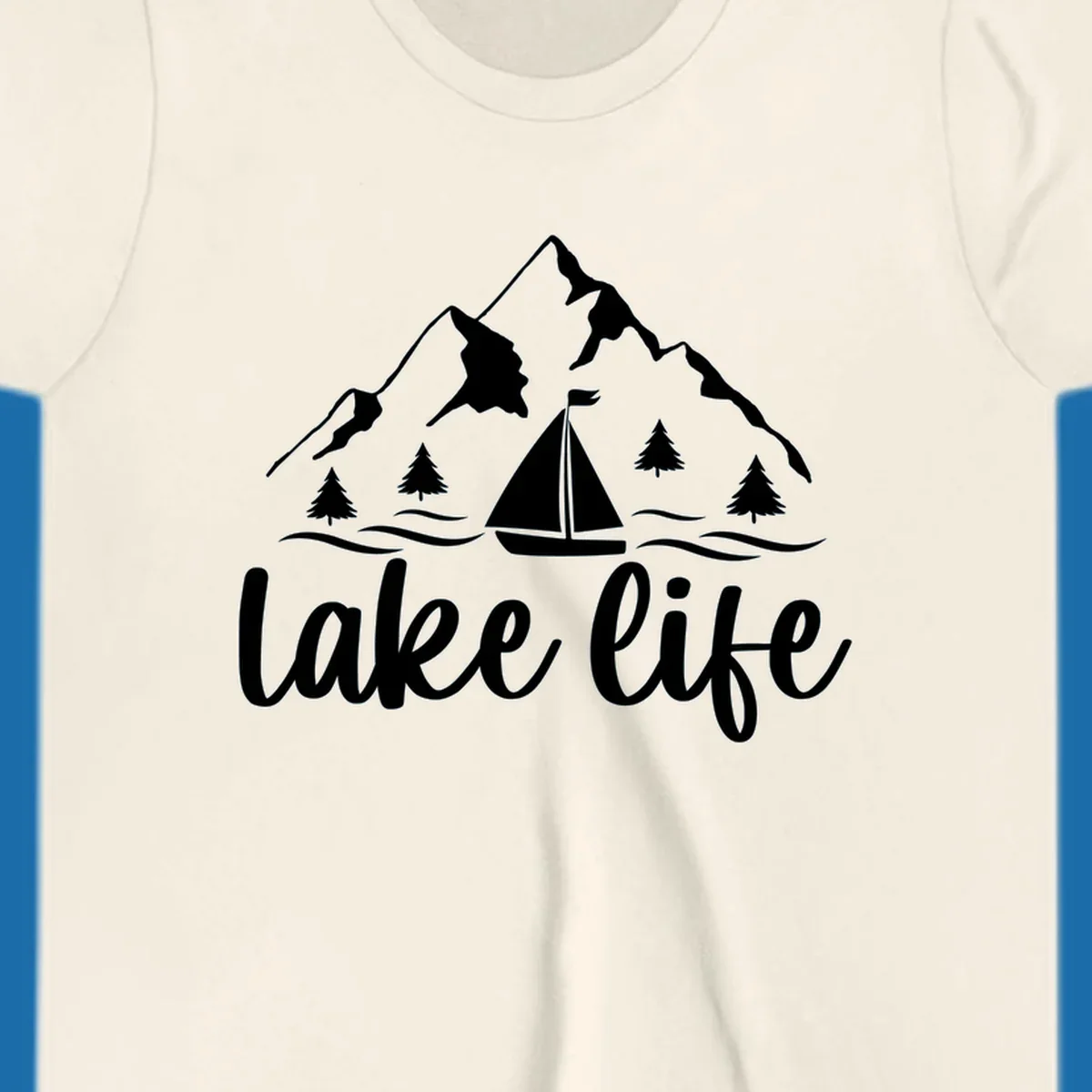 Lake life mountain sailboat scenic design with mountains, trees, sailboat, and text.