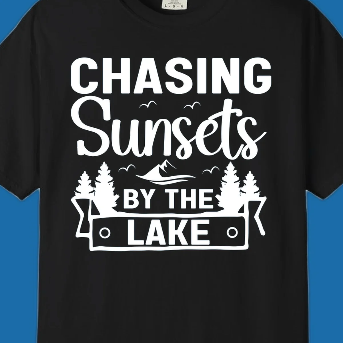 Chasing sunsets by the lake design with text, trees, mountains, and birds.