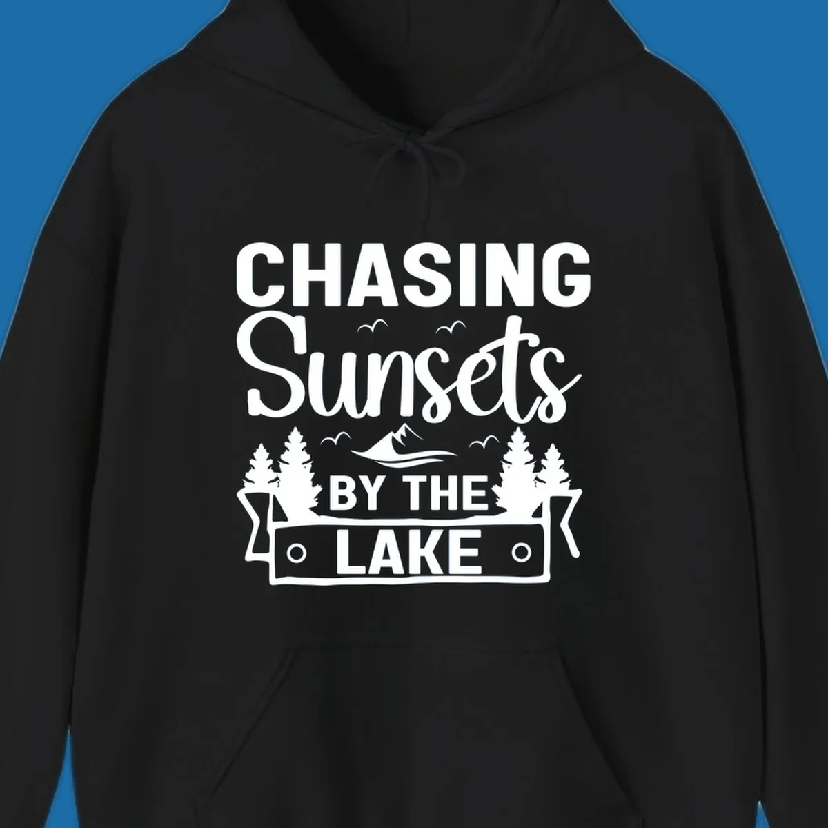 Chasing sunsets by the lake design with text, trees, mountains, and birds.