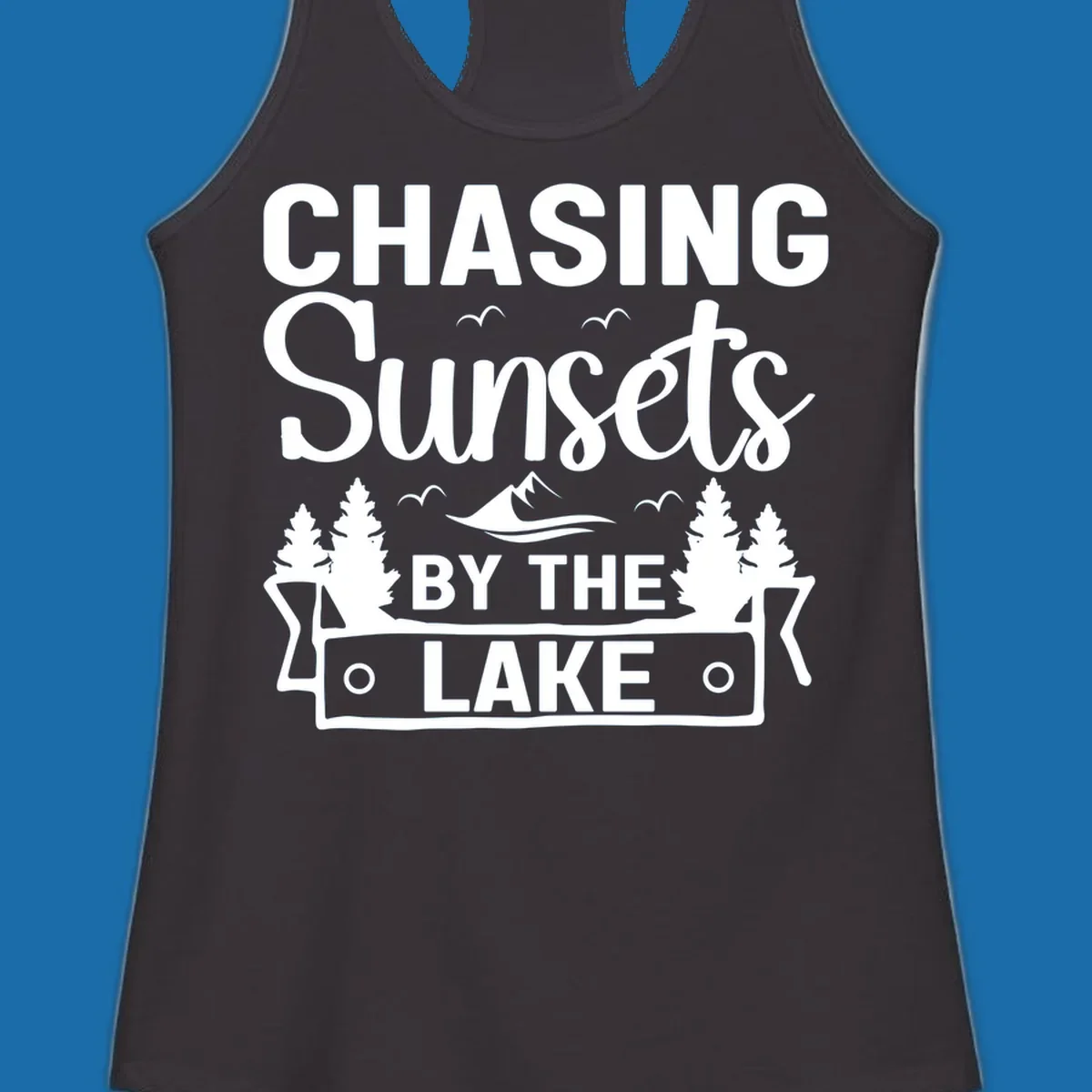 Chasing sunsets by the lake design with text, trees, mountains, and birds.