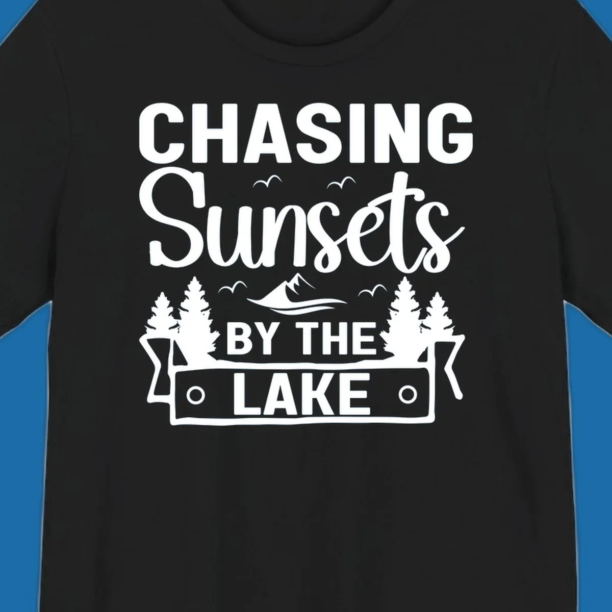 Chasing sunsets by the lake design with text, trees, mountains, and birds.