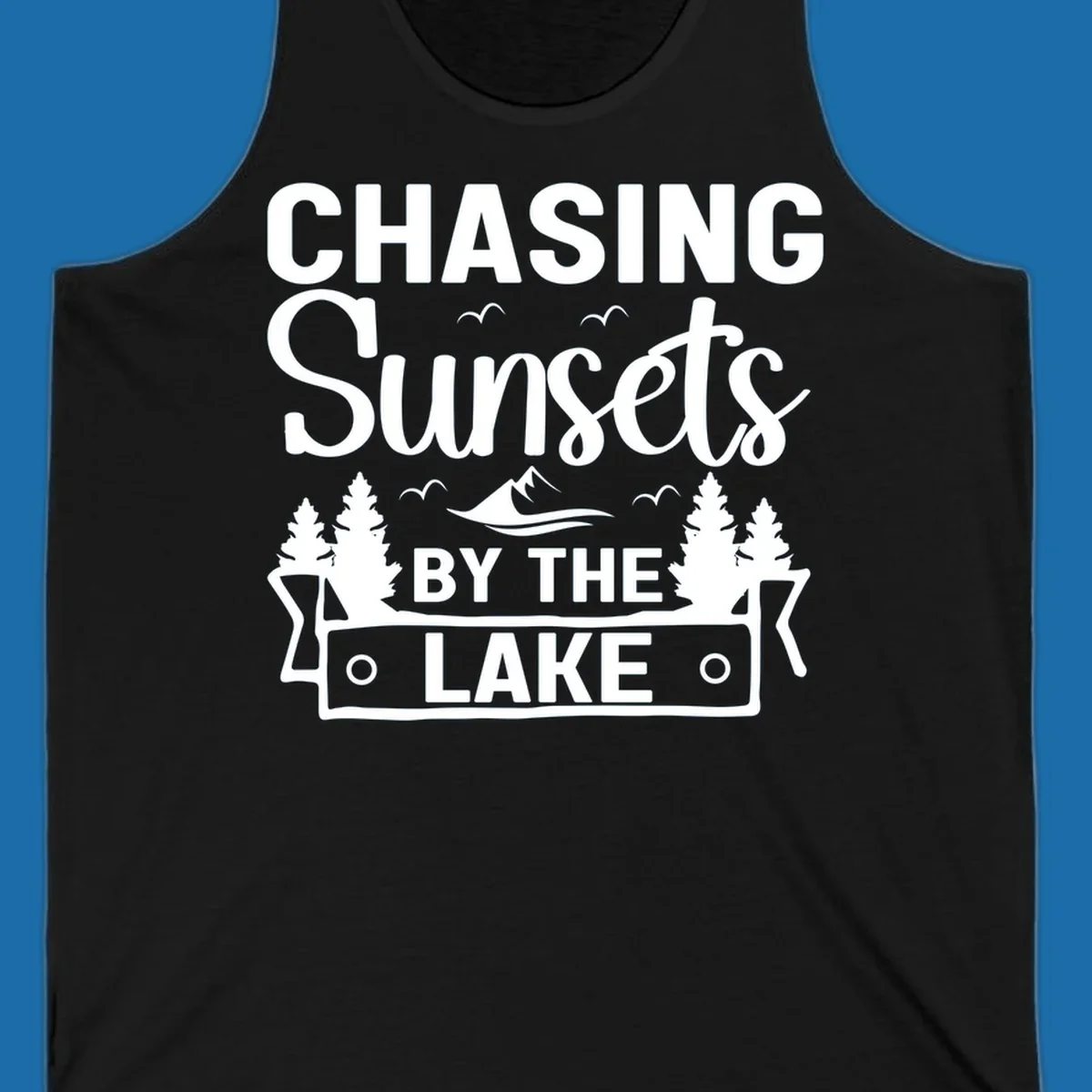 Chasing sunsets by the lake design with text, trees, mountains, and birds.