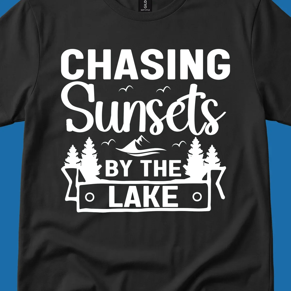 Chasing sunsets by the lake design with text, trees, mountains, and birds.