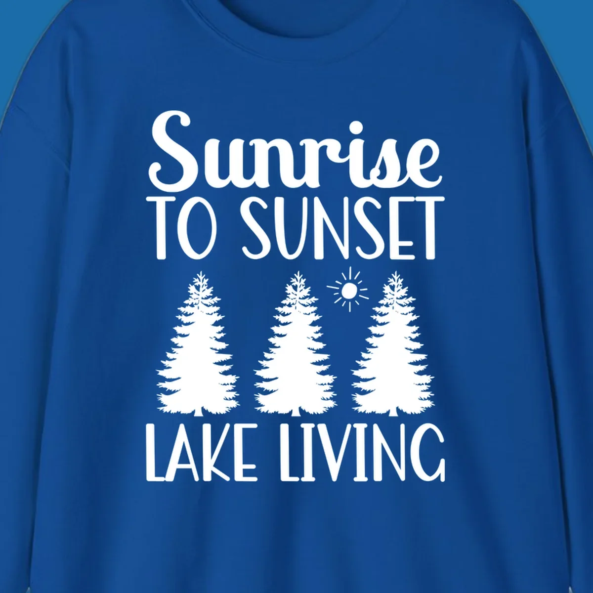Sunrise to sunset lake living text with pine trees and sun graphic. lake-living-sunrise-sunset