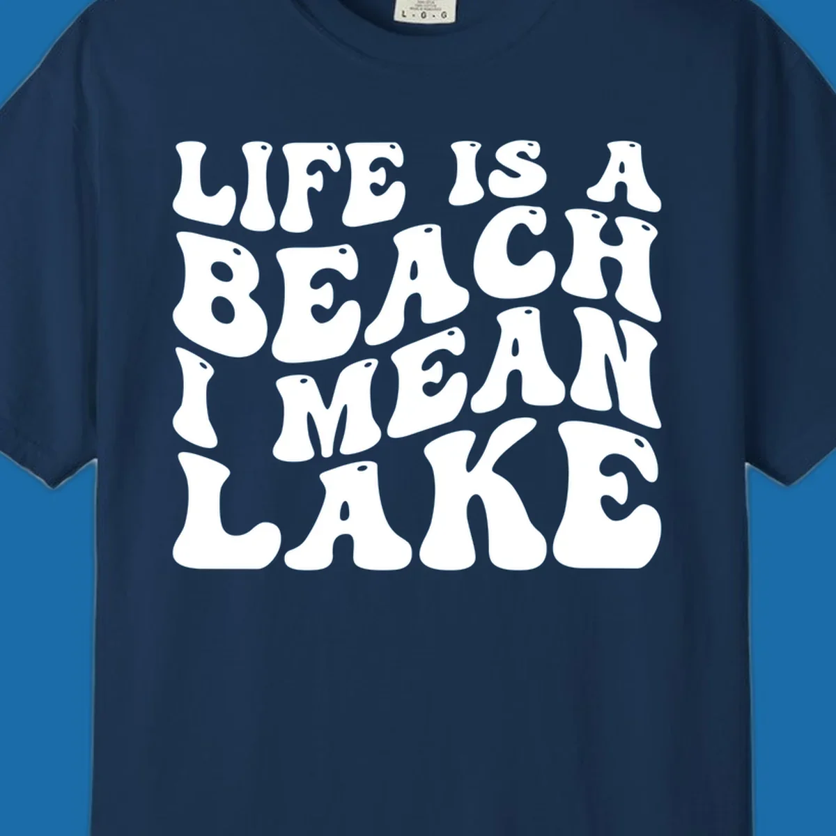 Retro typography design with the phrase "LIFE IS A BEACH I MEAN LAKE" for lake-themed apparel.