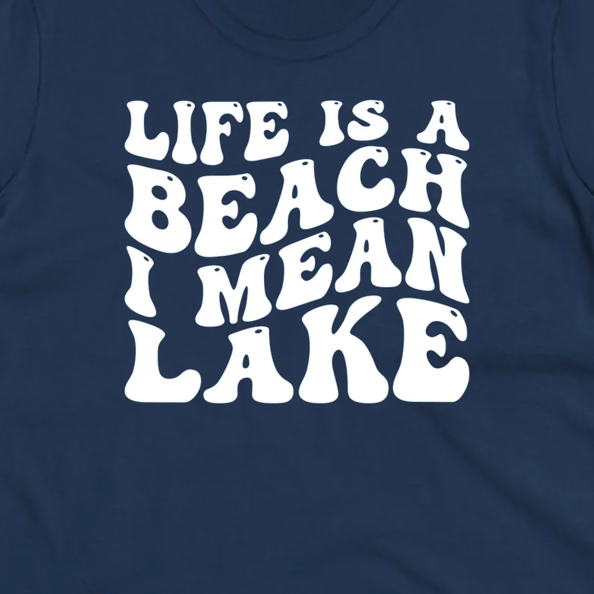Retro typography design with the phrase "LIFE IS A BEACH I MEAN LAKE" for lake-themed apparel.