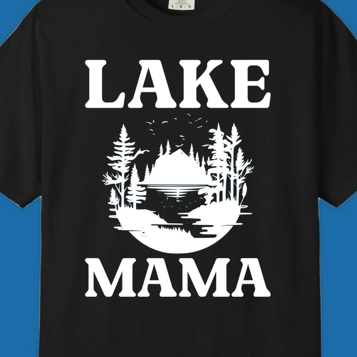 Lake Mama nature scene with trees, lake, and mountains silhouette.