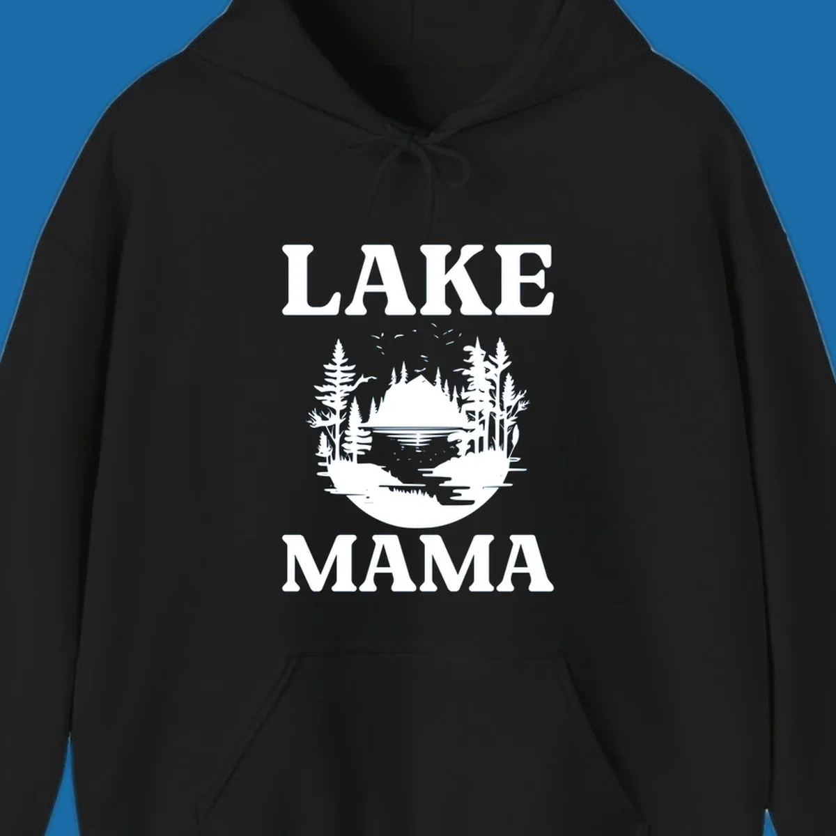 Lake Mama nature scene with trees, lake, and mountains silhouette.