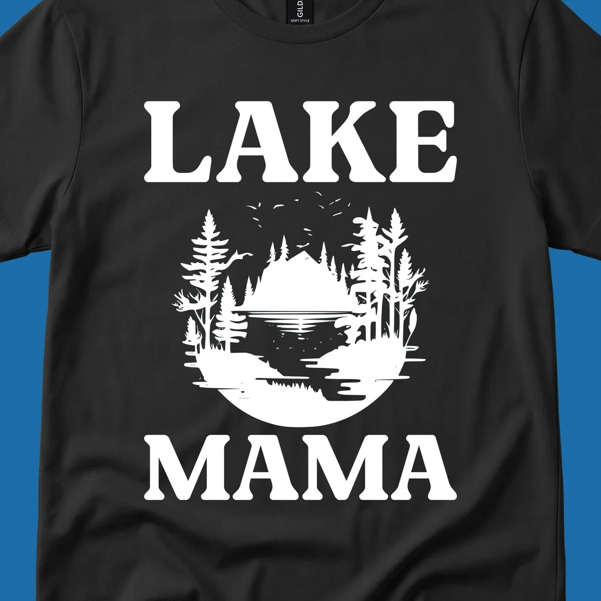 Lake Mama nature scene with trees, lake, and mountains silhouette.