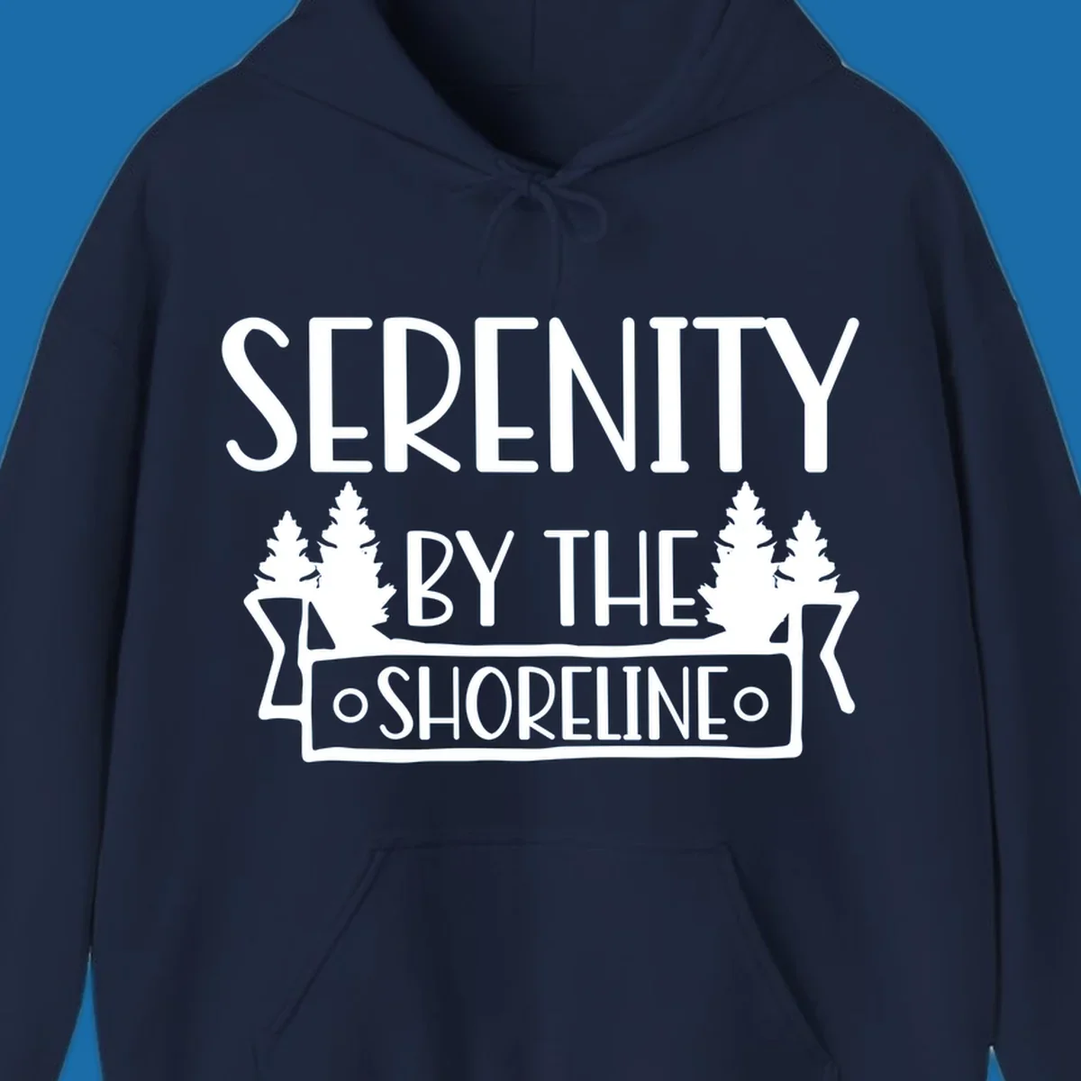 Serenity By The Shoreline text with pine trees and banner