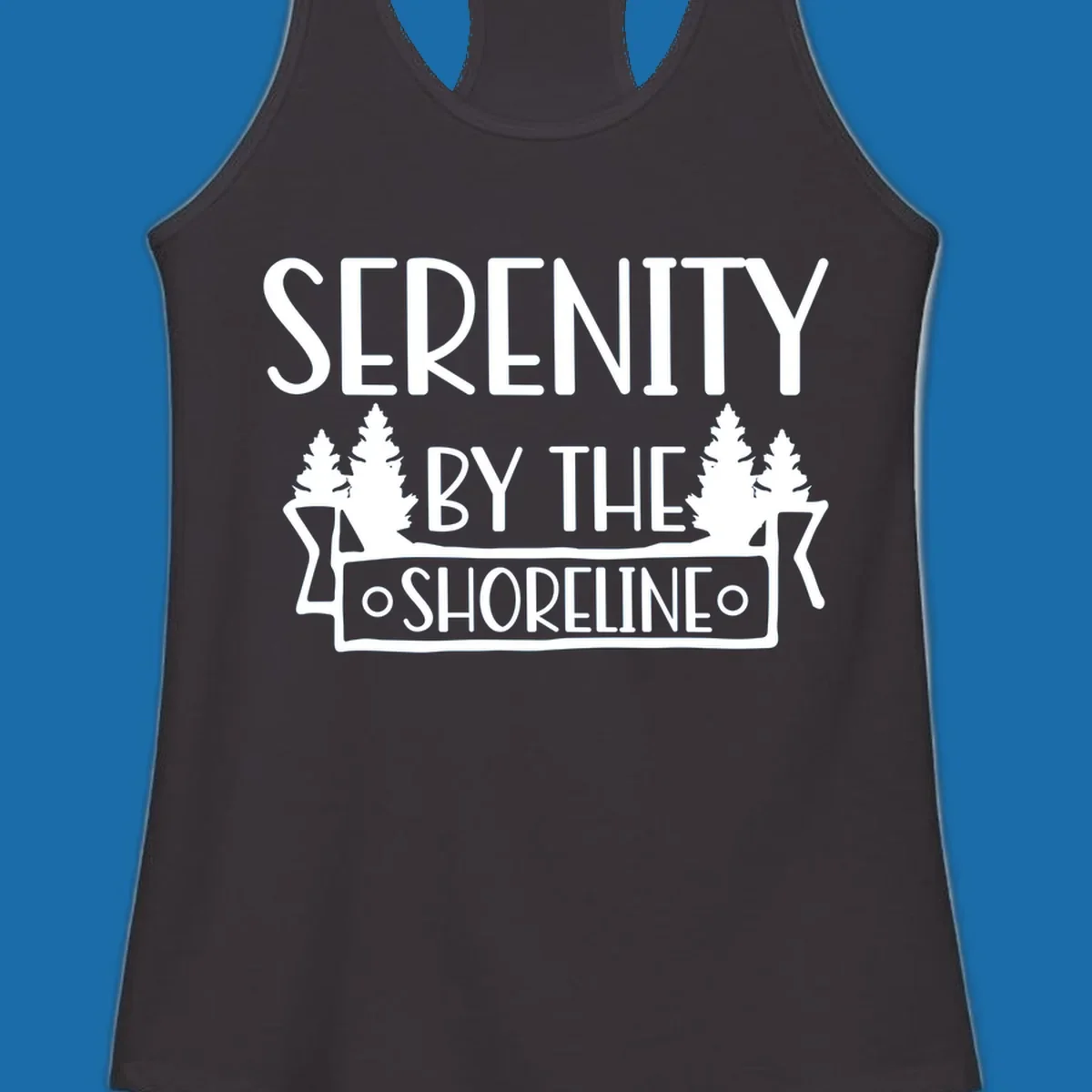 Serenity By The Shoreline text with pine trees and banner