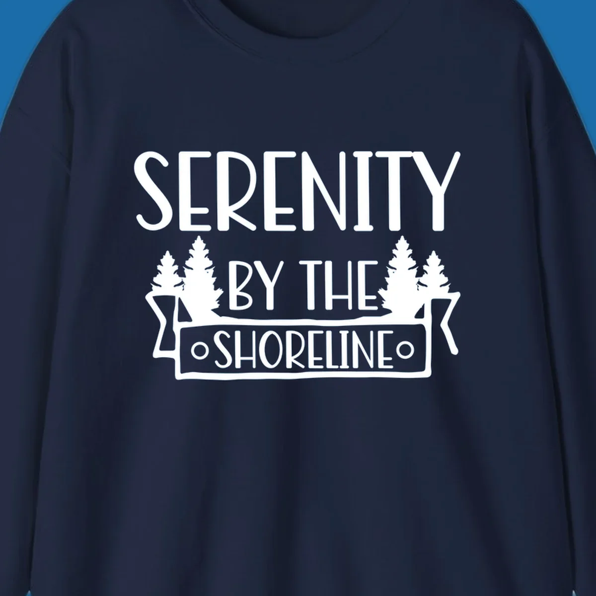 Serenity By The Shoreline text with pine trees and banner